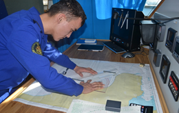Cadet working with a nautical chart